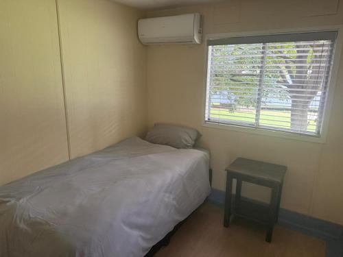 a small bedroom with a bed and a window at The View on Vaal Resort in Sasolburg