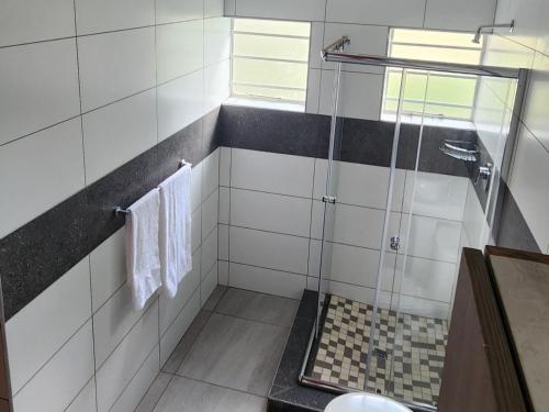 a bathroom with a shower with a glass door at The View on Vaal Resort in Sasolburg