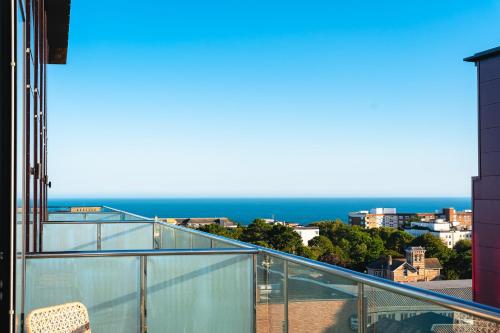 a balcony with a view of the ocean at Penthouse at the Chocolate Box in Bournemouth