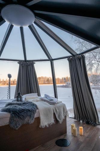 a bedroom in a tent with a large window at Ikaalinen SPA & Resort in Ikaalinen
