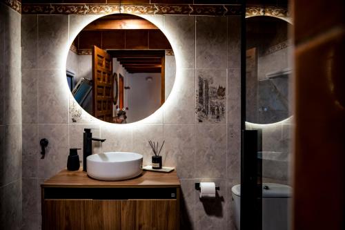 a bathroom with a sink and a mirror at El Rincón del Silencio in Entrala