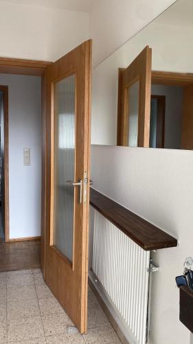a room with a wooden door and a mirror at Ferienwohnung Breininger in Lemberg