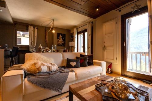 a living room with a couch and a table at Luxury Lodges by Grand Hotel Sitea in Sestriere