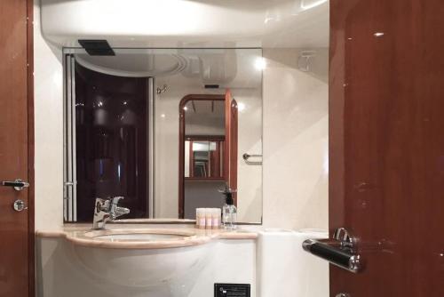 a bathroom with a sink and a large mirror at The Duke Superyacht - LINDIAN in Lindos
