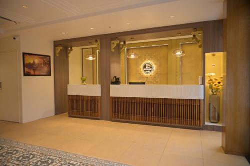 a lobby with a reception desk in a building at Hotel Bliss Kashi in Kakarmatha