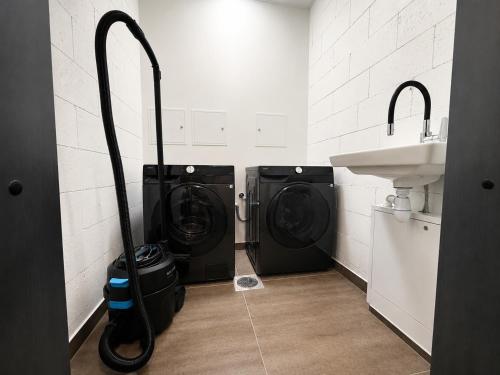 a bathroom with two washing machines and a sink at Filosoofi Suites in Tartu