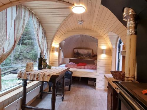 a room with a bed with a table and a window at Igluhuts Passail in Passail