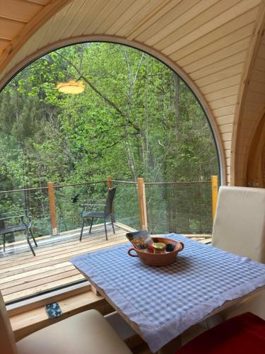 a table with a bowl of fruit on a porch at Igluhuts Passail in Passail