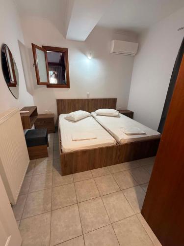 a small bedroom with a bed and a mirror at Mirina View Apartment #2 in Myrina