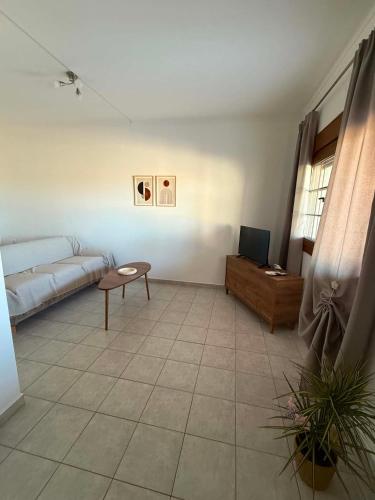 a living room with a couch and a table at Mirina View Apartment #2 in Myrina