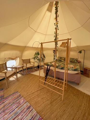 a bedroom with a bed in a tent at Galleriet BnB in Stenkyrka