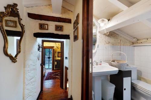 a bathroom with a sink and a mirror at Villa Daphne Pool And Jacuzzi in Vescina