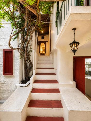 a stairway leading up to a building with a red carpet at Kumaon Cottage, Nainital - AM Hotel Kollection in Nainital