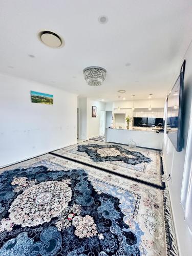 an empty room with a large rug on the floor at Noble place in Loganlea in Loganlea
