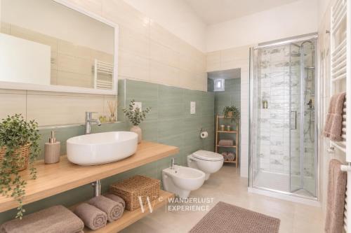 a bathroom with two sinks and a shower at Wanderlust Experience Loggiato del duca in Bitonto