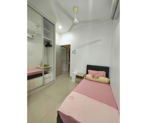 a bedroom with a pink bed in a room at 61 StayAtHome in Nibung Tebal
