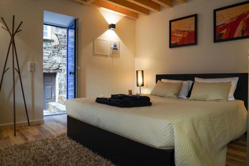 a bedroom with a large bed in a room at Casas Martinho - Algares in Piódão