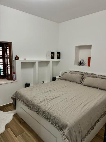 a white bedroom with a large bed in it at Bonaca Residence in Makarska