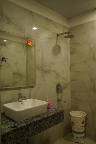a bathroom with a sink and a mirror at Hotel High Residency in New Delhi