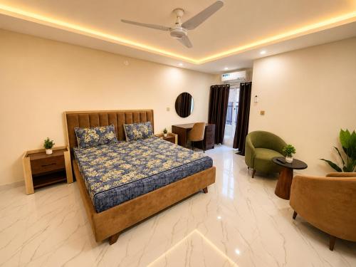 a bedroom with a bed and a living room at Motorway Majesty Heights - Near Islamabad International Airport and Motorway in Islamabad