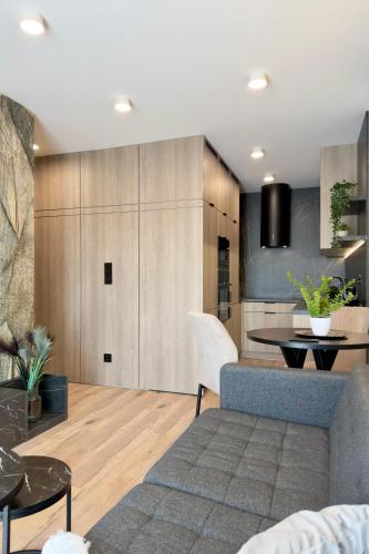 a living room with a couch and a table at Apartament Stara Fabryka 42 in Włocławek