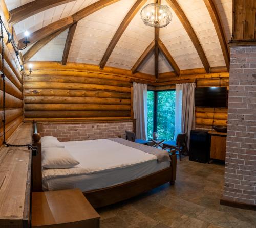 a bedroom with a bed in a room with wooden walls at Getahovit Resort in Ijevan