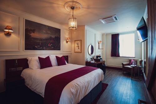 a hotel room with a large bed and a window at The Goat in Boots in London