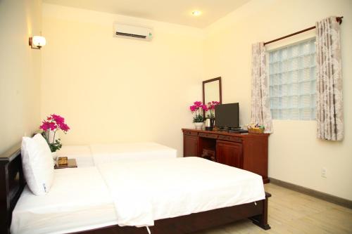 Giường trong phòng chung tại Minh Tam Hotel and Spa