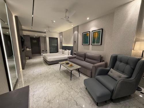 a living room with couches and a couch and a table at Vijan Mahal in Jabalpur