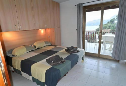 a bedroom with a bed with towels on top of it at Maremonti in Letojanni