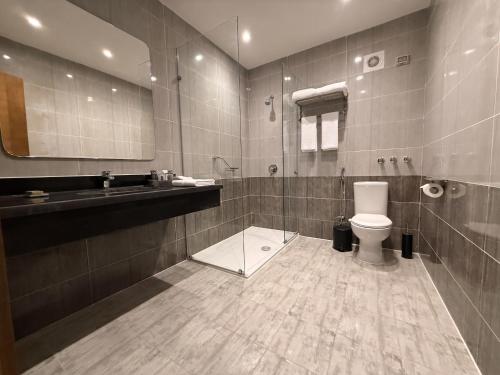 a bathroom with a toilet and a sink and a mirror at TIME Marina North Coast in El Alamein