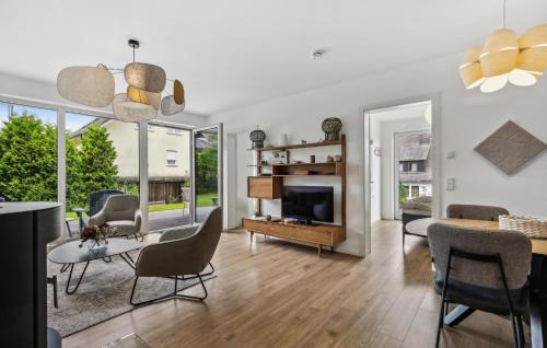 a living room with a table and chairs and a television at Ferienfreude in Winterberg