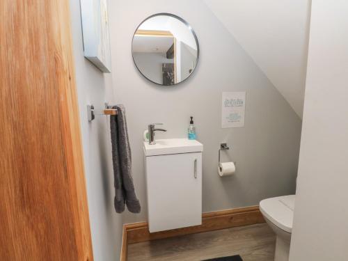 a bathroom with a sink and a mirror at Barn 1 in Sandbach