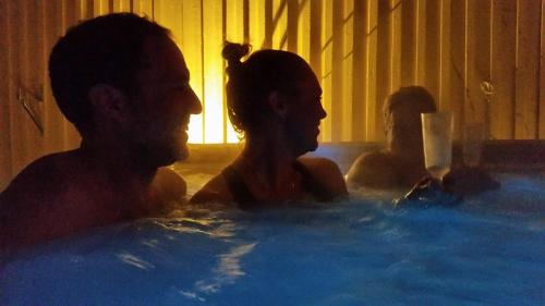 a man and woman sitting in a hot tub at Pensionat Ankargården in Öregrund