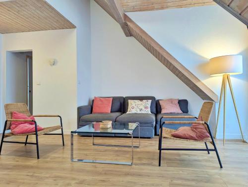 a living room with a couch and two chairs at L'Hirondelle - Charming flat - in Blotzheim