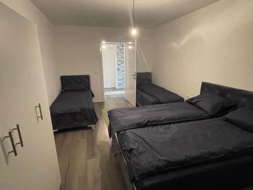 a small room with two beds and a window at Apartmen Emina 1 in Doglodi