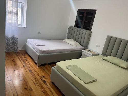 a room with two beds and a couch at Villa K & N in Sarandë