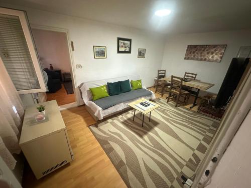 a living room with a couch and a table at Apartman Kostadinovic in Pirot