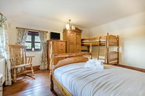 a bedroom with two bunk beds and a tv at 3 Bed in Acle oc-b41410 in Acle