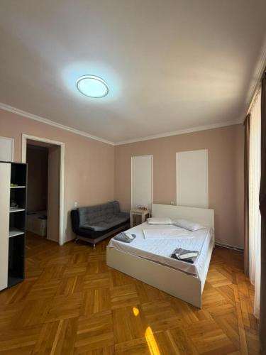 a bedroom with a bed and a couch in it at best hotel yerevan in Yerevan