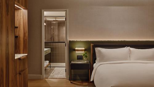 a hotel room with a bed and a walk in closet at Hotel Nelligan in Montreal