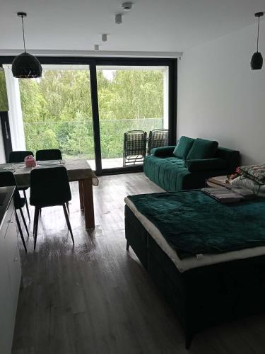a living room with a couch and a table at Sea and lake KinKas in Mielno