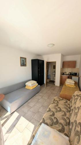 a living room with a couch and a kitchen at Pelikan I in Rowy