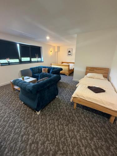 a living room with a couch and a bed at Motel Anić in Novi Travnik