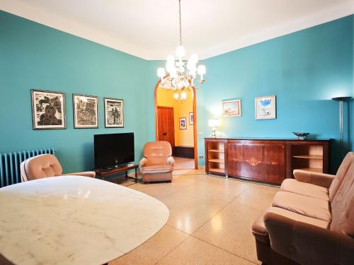 a living room with a table and chairs and a tv at Dimora Cavour in Monopoli