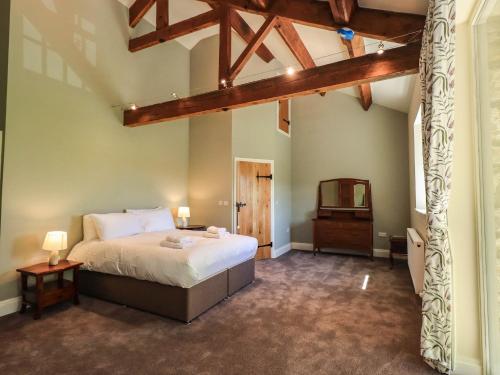 a bedroom with a bed and a tv in it at Ragged Hall Barn in Settle