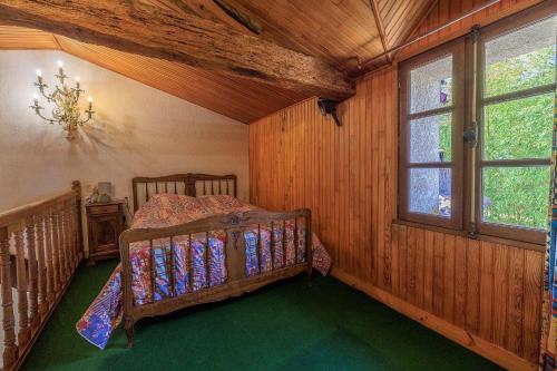 a bedroom with a bed in the corner of a room at L'Etable de Sauvignac - Avec piscine privée in Sauvignac