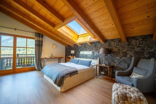 a bedroom with a large bed and a skylight at Jagdhaus Umlberg in Umlberg