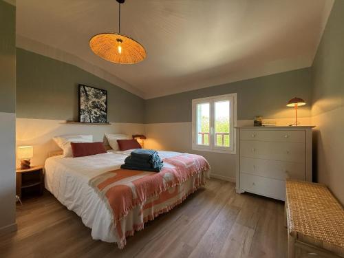 a bedroom with a bed and a window and a dresser at Pegartea in Mendionde
