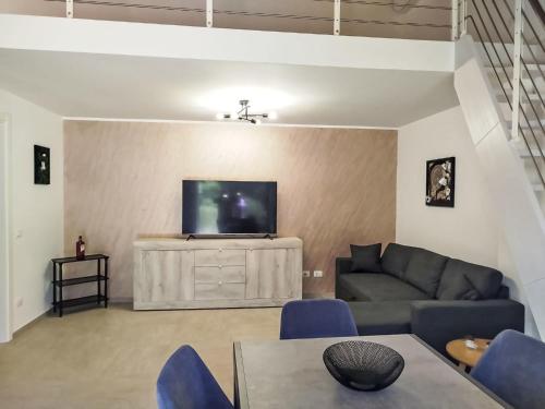 a living room with a couch and a flat screen tv at Apartment in Riga by Interhome in Cisano sul Neva